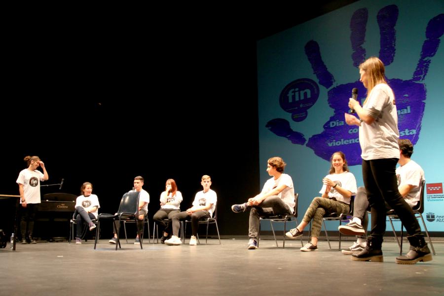 IX Jornadas Alcobendas por un Futuro sin Violencia - Imagen de un grupo de alumnos con la camiseta contra la violencia charlado sobre ella.