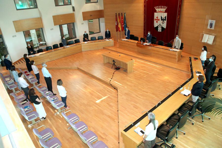 Vista cenital del salón de plenos con concejales en pie durante la pandemia de COVID 19