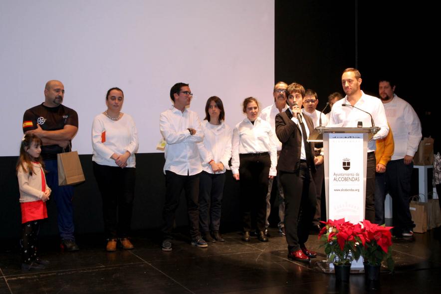 Presentación Calendario APAMA 2020 - Imagen de los presentadores junto a un grupo de personas sobre el escenario.