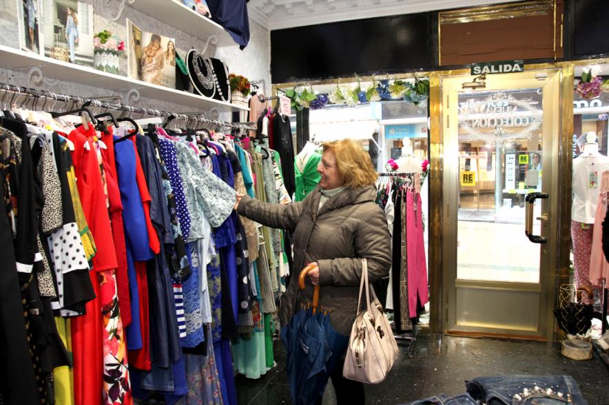 Visita Alcostock 2018 - Imagen de clienta en el interior de un comercio mirando el género.
