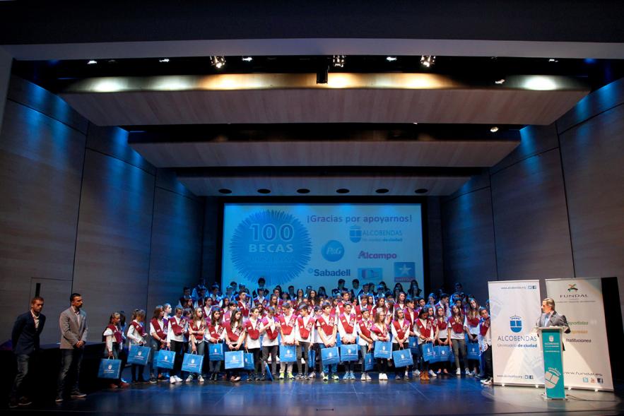 Entrega de 100 Becas FUNDAL 2017 - Imagen de los niños becados con el alcalde García de Vinuesa y otra autoridad en el escenario.
