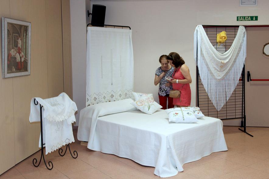 Inauguración Exposición de Bordados Casa de Extremadura -  Colchas y sábanas  expuestas. 