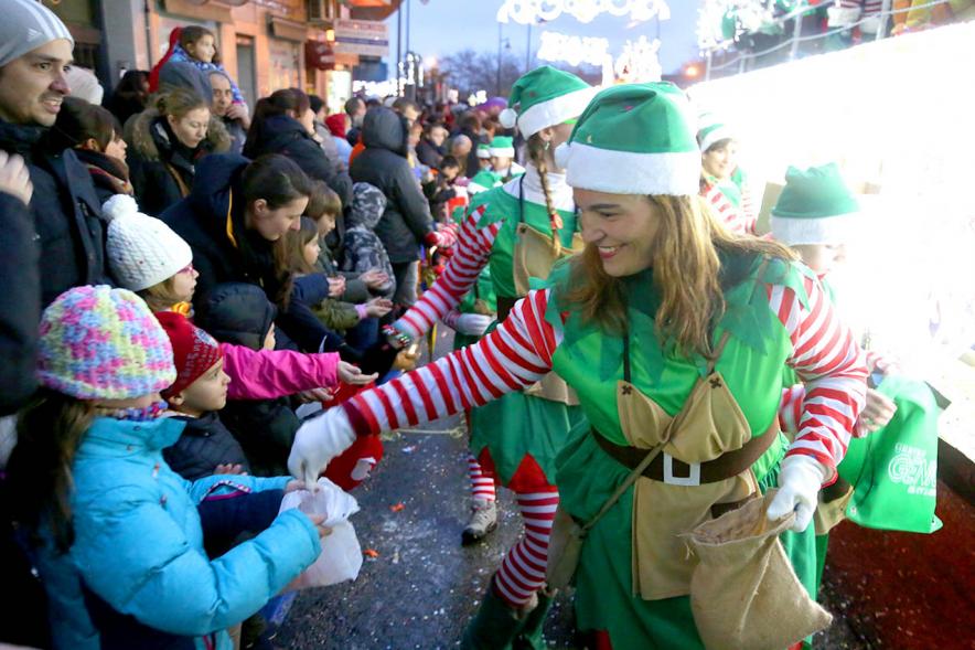 Cabalgata de Reyes 2018 - Imagen de unas personas disfrazadas de duendes repartiendo caramelos entre los niños.