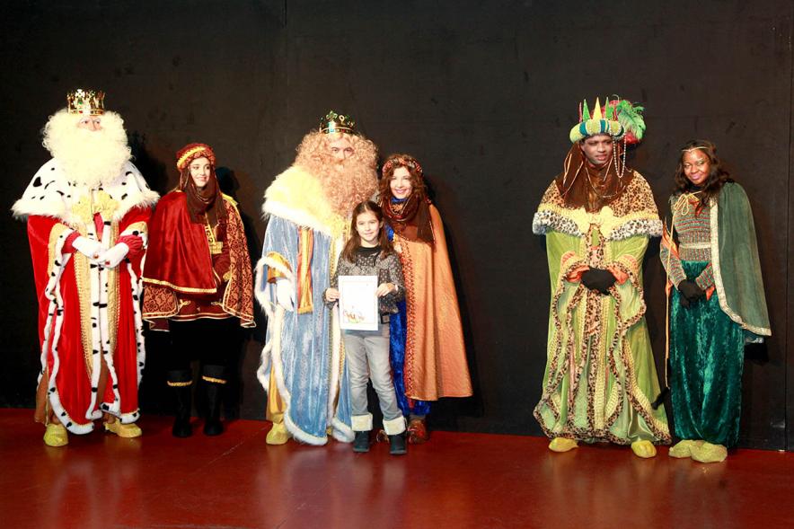 Cabalgata de Reyes 2017 - Imagen de los Reyes Magos y sus pajes en el escenario y unos niños.