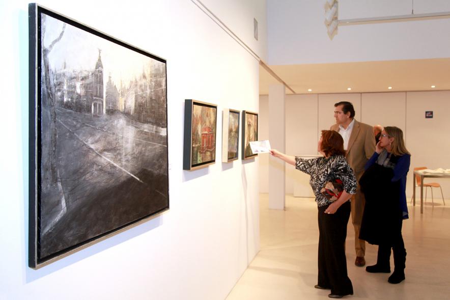 Inauguración Exposición de Charo Vaquerizo "Visiones Urbanas" - Imagen de personas mirando los cuadros de la exposición.