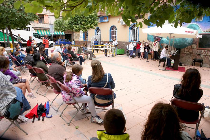 Concierto Infantil Escuela de Música en Distrito Centro -  Imagen lateral de los asistentes y la zona al fondo  donde los niños tocan.