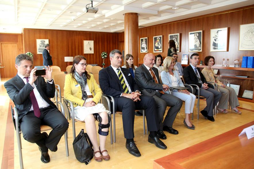 Representantes de las partes esperando su turno de firma