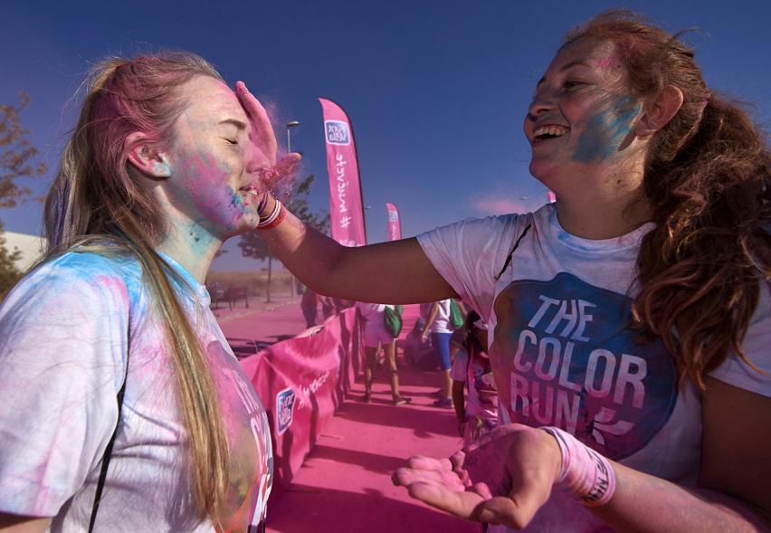 Carrera Color Run - Imagen participante en la carrera con nubes de polvo de color rosa.