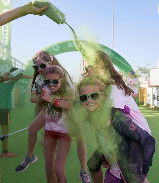 Carrera Color Run - Imagen de participantes en la carrera después de recibir polvo de color verde.