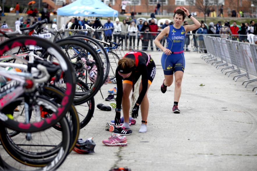 Duatlón Villa de Alcobendas 2017 - Imagen de una  corredora en el momento de coger la bicicleta para seguir con la carrera de bici.