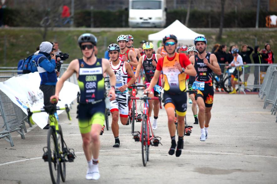 Campeonato de España de Duatlón -  Plano central de los  numerosos participantes llevando la bicicleta de la mano.