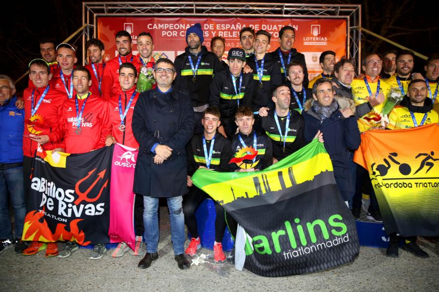 Campeonato de España de Duatlón -  Primer plano del alcalde Sánchez Acera delante del equipo ganador situado entre el segundo y el tercero.