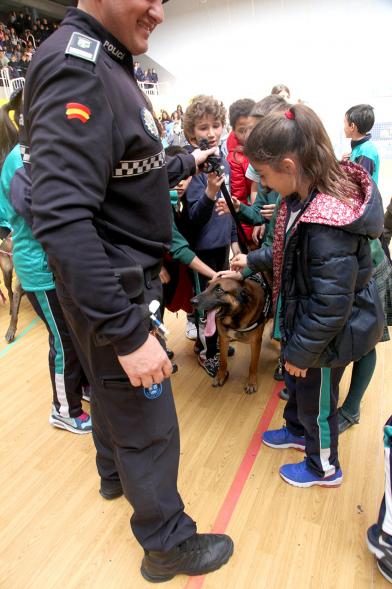 Iª Exhibición de la Unidad Canina de la Policía Local - Imagen de un policía y su perro policía junto a unos niños.