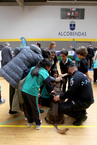 Iª Exhibición de la Unidad Canina de la Policía Local - Imagen de un policía y su perro policía junto a unos niños.