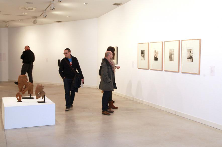 Inauguracion Exposición "La Idea de un Signo" - Imagen de personas mirando cuadros expuestos.