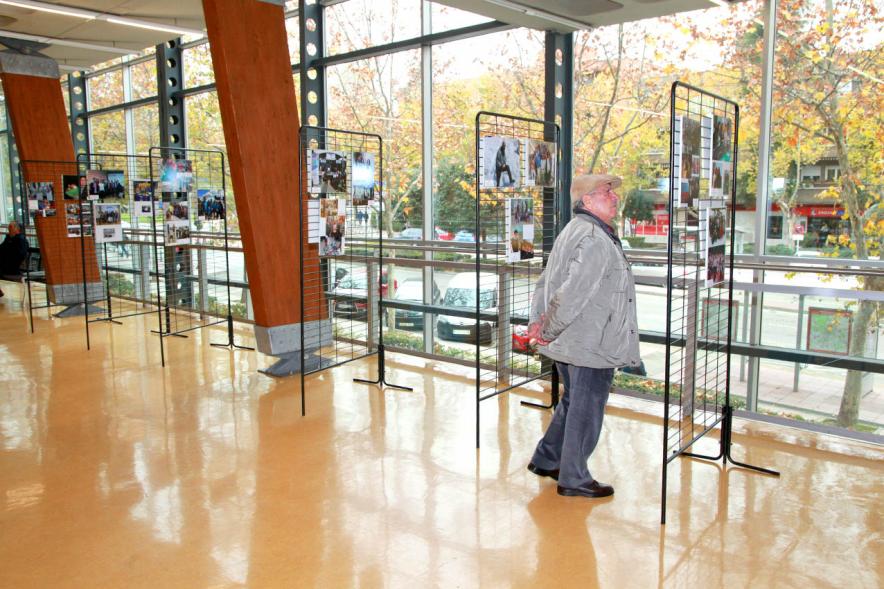 Inauguración Exposición Voluntariado en C.C. Pablo Iglesias - Imagen de una persona mirando la fotografías expuestas en la Exposición Voluntariado.