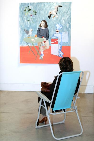 Inauguración Exposición "Se non è Vero, è Ben Trovato" de Los Bravú - Plano de una visitante sentada en una silla de playa frente a una obra expuesta.