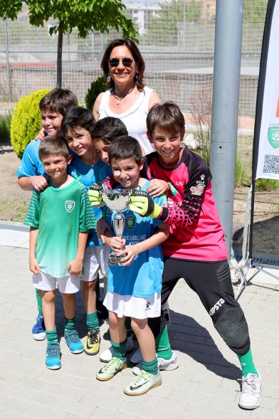 Torneo de Fútbol Sala Alcobendas Futsal - Imagen de un equipo de futbol sala infantil con su trofeo posando junto a la persona que se lo ha entregado.