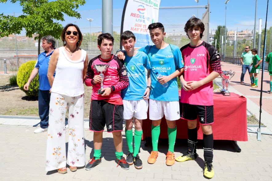 Torneo de Fútbol Sala Alcobendas Futsal - Imagen de un grupo de jugadores con su trofeo posando junto a la persona que se lo ha entregado.
