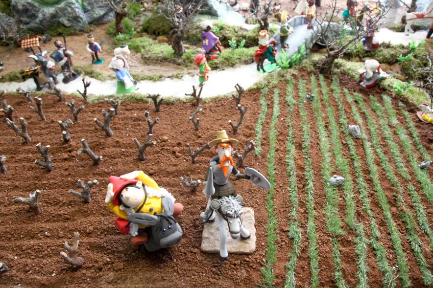 Sancho y Quijote en un campo sembrado