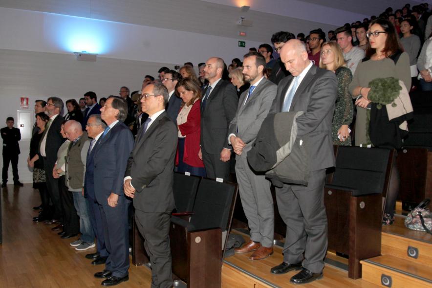 En Recuerdo del Holocausto - Imagen de los asistentes  de pie por respeto.