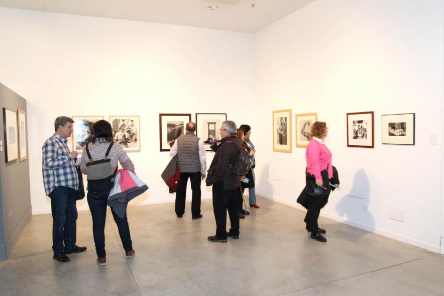 Asistentes al evento mirando fotografías de la colección – 2020