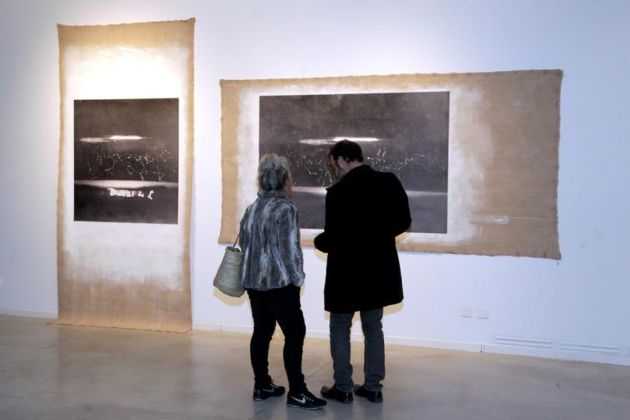 Inauguración Exposición "La Cámara de Niebla" de Linarejos Moreno - Los visitantes contemplan dos obras.