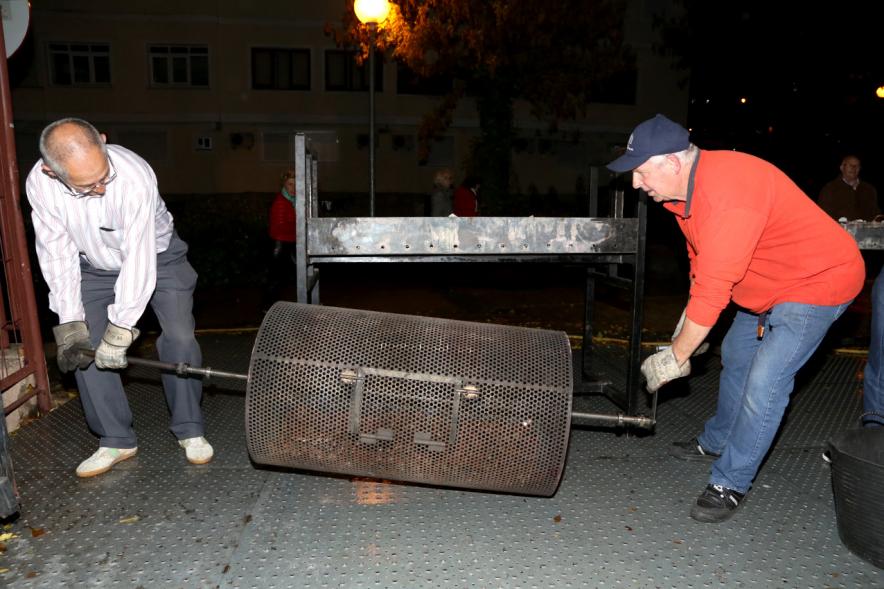Fiesta del Mangosto de la Xuntanza de Galegos 2016 - Imagen de persona con las brasas de la hoguera, poniendo las castañas a asar.