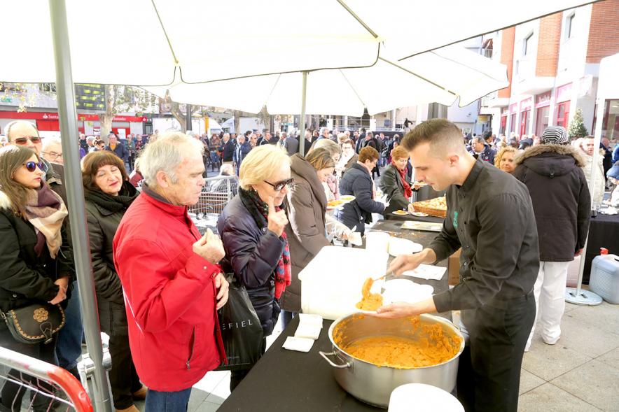 Misa, Migas y Gachas - Imagen de personas repartiendo la comida y personas cogiendo la comida.