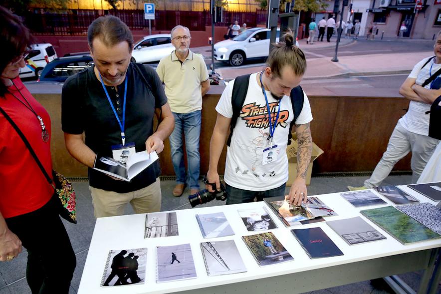 Noche en Blanco 2018 - Imagen de personas reunidas en la entrada del Centro de Arte...mirando las mesas con objetos expuestos.
