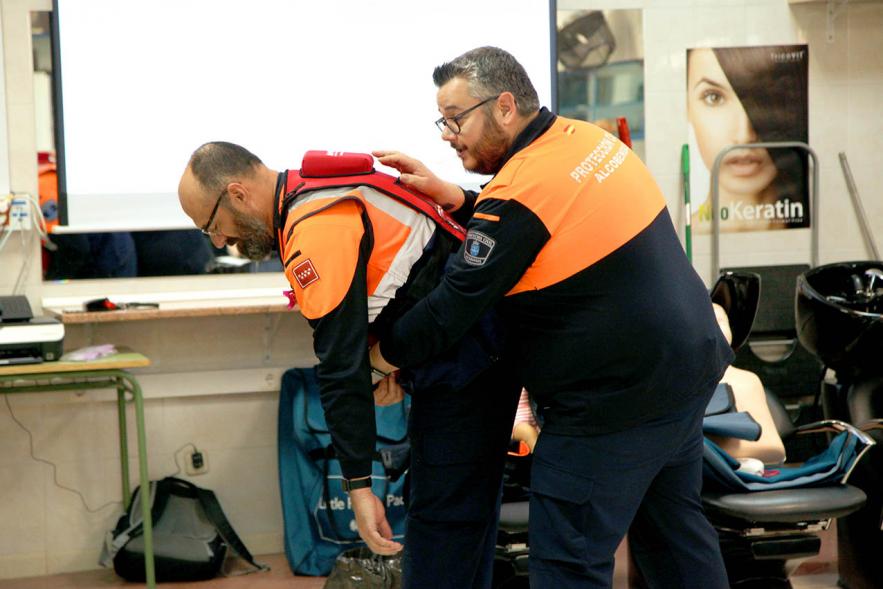 Miembros de protección civil enseñando a ejecutar la maniobra de Heimlich