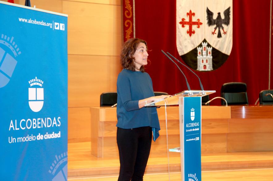 Recepción Programa Erasmus IES Giner de los Ríos - Imagen de una mujer dirigiendo unas palabras a las personas presentes en el acto.