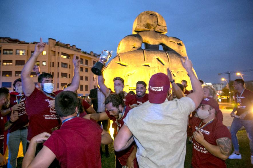 Celebración del Club Rugby Alcobendas en la Menina la Copa del Rey -Imagen de la Menina iluminada y  los eufóricos jugadores del Alcobendas Rugby,  alrededor.