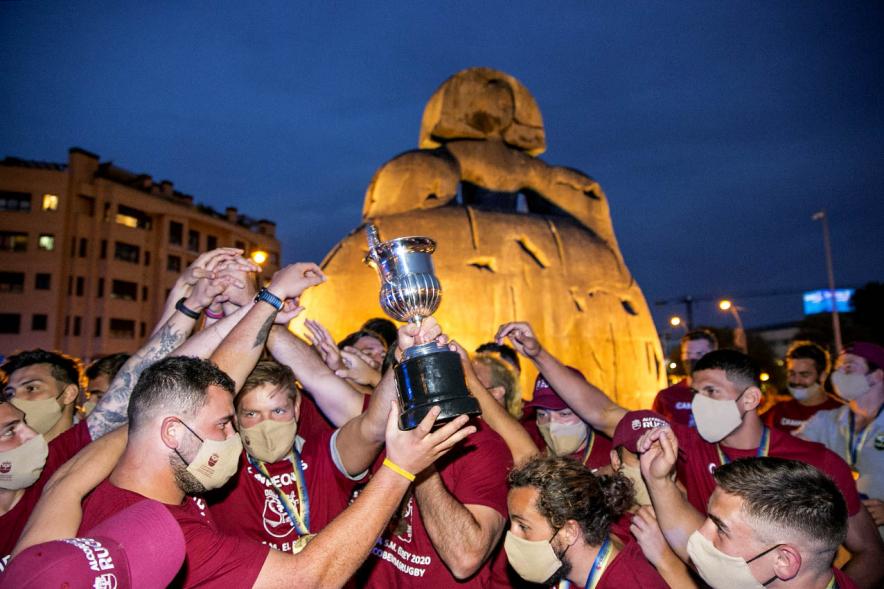 Celebración del Club Rugby Alcobendas en la Menina la Copa del Rey -  Imagen del trofeo levantado  por un jugador del Alcobendas Rugby, de fondo la Menina.