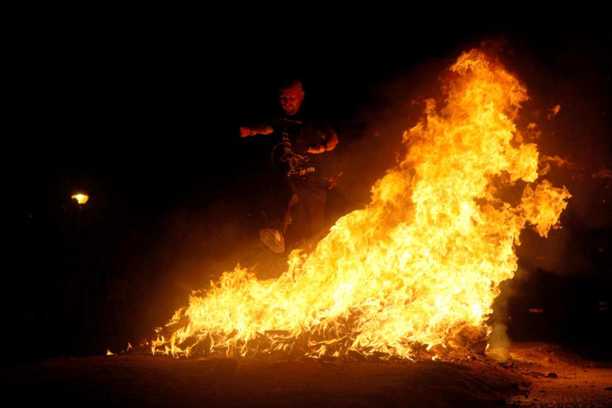 Noche de San Juan 2016 - Personas saltando la hoguera de San Juan.