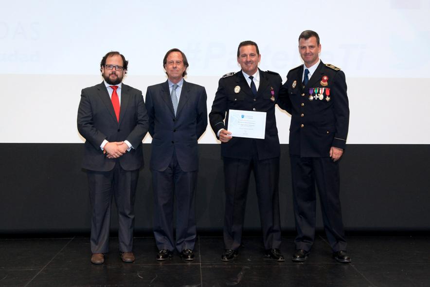 Festividad de San Juan de la Policía Local - El alcalde García de Vinuesa y otras autoridades en el escenario con un galardonado.