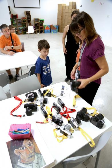 Taller de Fotografía con Niños en el Centro de Arte - Imagen de monitora del taller impartiendo clase a los niños participantes.