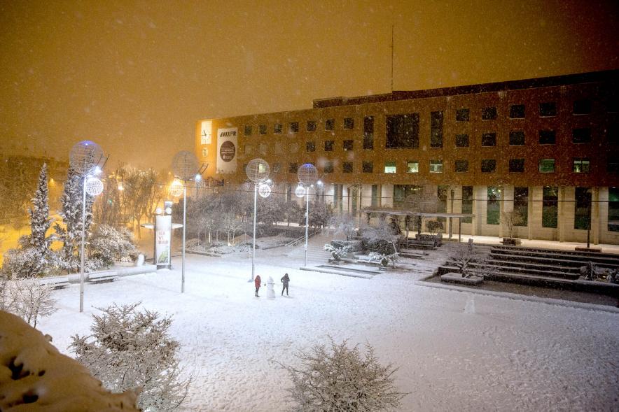 Vista general de la Plaza Mayor de Alcobendas completamente nevada con muñeco de nieve en el centro