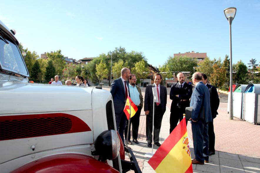 Miembros del ayuntamiento observando un autobus retro