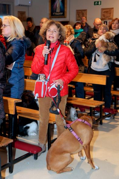 Bendición de Animales por San Antón en la Parroquia San Juan XXIII - Imagen de una persona en el interior del templo,con su perro y en la otra mano tiene un micrófono... con lo cual estará participando en la misa de algún modo.