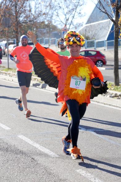 San Silvestre 2018 - Primer plano de un corredor disfrazado de pájaro de colores.