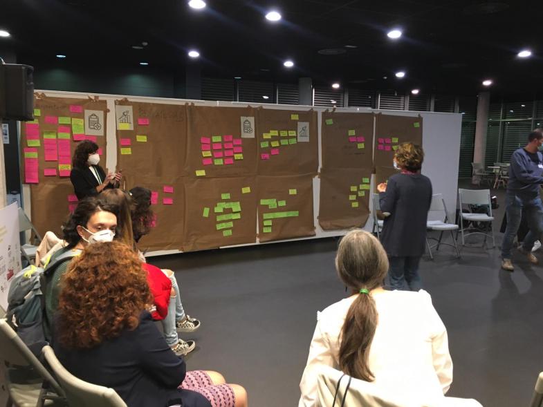 Foro AMPAS - Imagen de una mesa redonda y una persona hablando en el centro para todos.