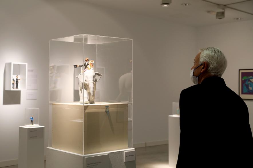  Inauguración Exposición "Miradas Tintinófilas" - Imagen de una persona mirando uno de los objetos de "Tintín" de Hergé que se exponen.