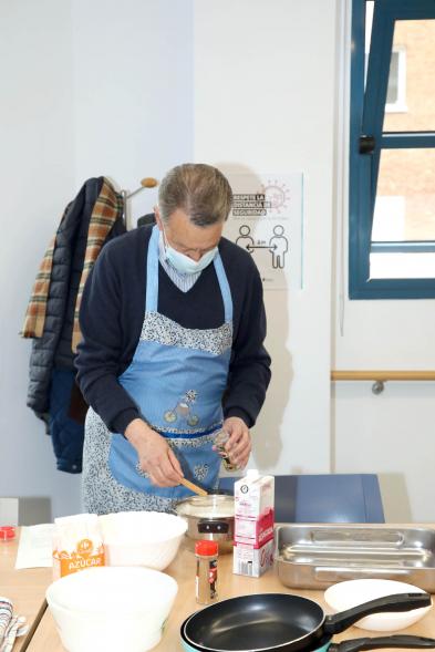 Visita al Taller de Cocina en el Centro de Mayores de la Calle Orense - Imagen de un participante en el curso mientras cocina.