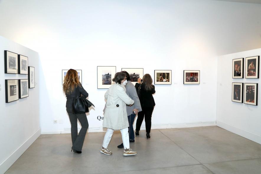   Coloquio y Visita Guiada a la Exposición "Cinco Miradas" - Imagen del público asistente admirando las fotografías.
