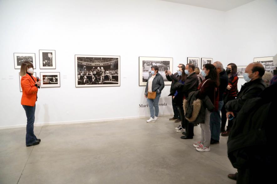Coloquio y Visita Guiada a la Exposición "Cinco Miradas" -  Imagen de Marisa Flórez realizando la visita guiada de su obra incluida en la exposición “Mujeres Reporteras: Cinco Miradas” y parte del público asistente.
