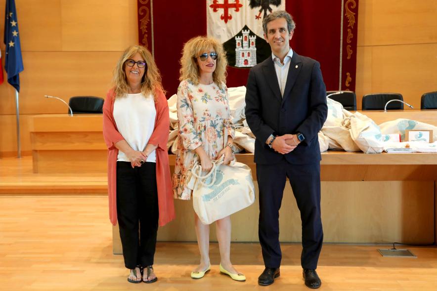 3a Entrega Canastillas Mis Primeros Pasos en Alcobendas - 2022 - Imagen del alcalde Aitor Retolaza y la concejala de Familia Inmaculada Puyalto posando con  una persona que acaba de recibir una canastilla.