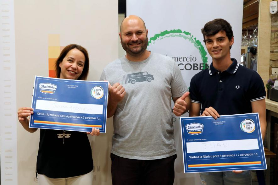 Entrega Premios Ruta de la Tapa 2022 - Imagen de un representante de la Asociación de Comerciantes y Hosteleros La Menina y de AICA haciendo entrega de un premio entre las personas que votaron.