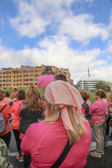 Menina con falda rosa y lazo humano con motivo del Día Mundial contra el Cáncer de Mama
