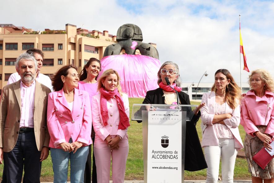 Menina con falda rosa y lazo humano con motivo del Día Mundial contra el Cáncer de Mama